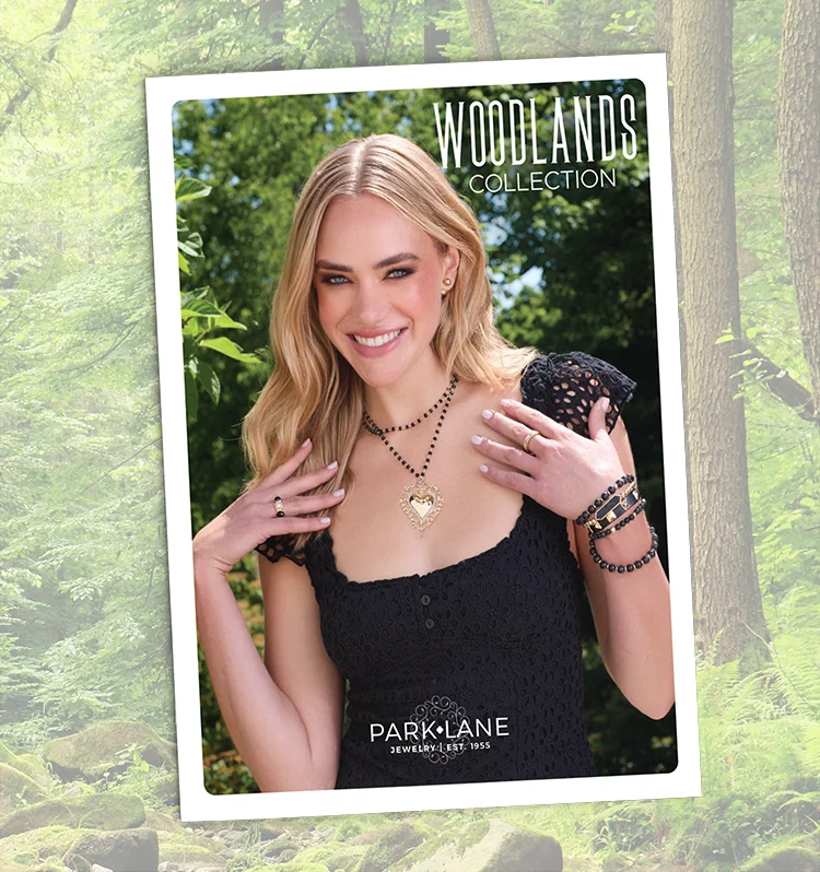 Catalog Cover for the Woodlands collection, with a Eoman in a black dress showing off her jewelry, in a forest setting